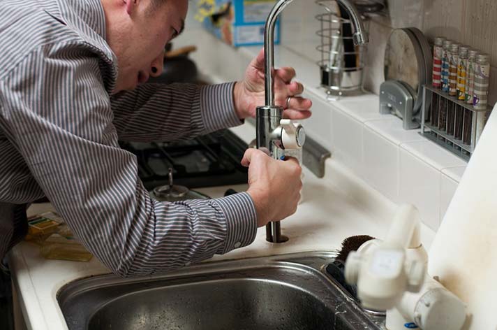 Plumber Repairing a Tap