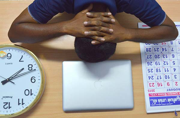 Man Stressed at Work with Head on Desk