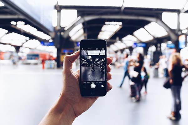 Holding iPhone at Railway Station