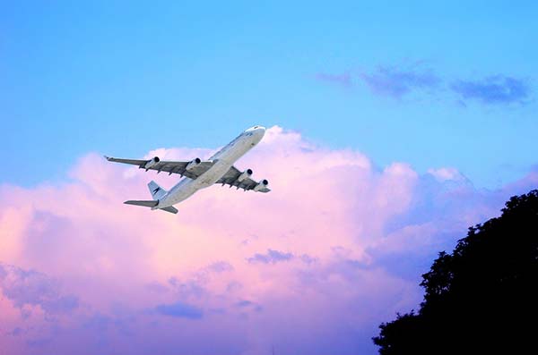 Plane Taking Off Against Purple Skies