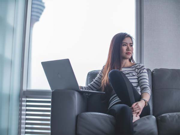 Asian Girl on Couch with Laptop