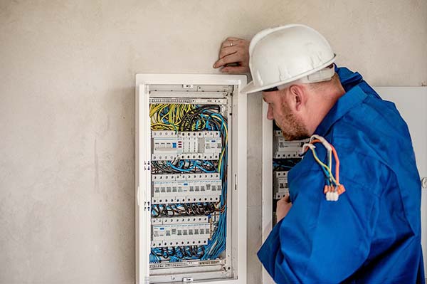 Electrician Inspecting Fuse Box