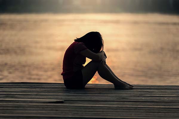 Girl Sat with Head Down