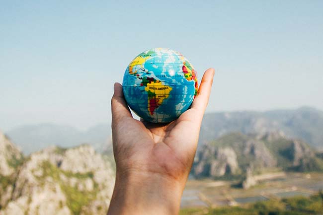 Holding a Small Earth Globe