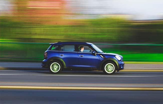 Man Driving Mini on Highway