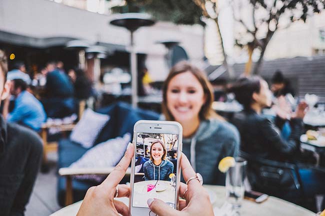 Taking Picture of Girl Using Phone