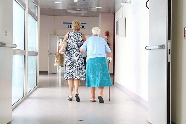 Lady Helping Senior Citizen Walk