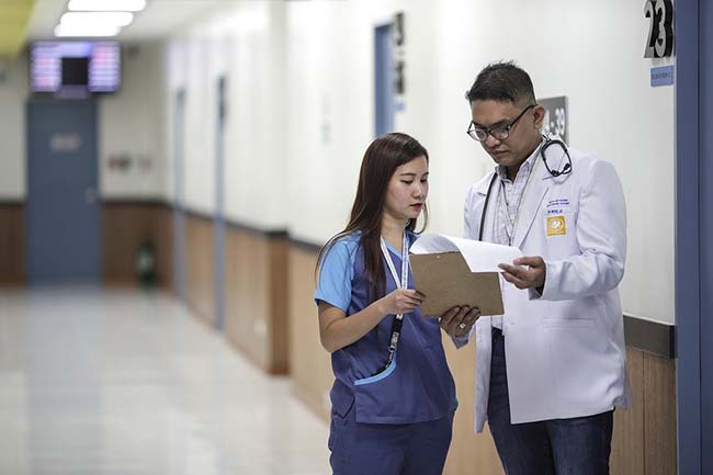 Two Doctors Reviewing Patient Notes