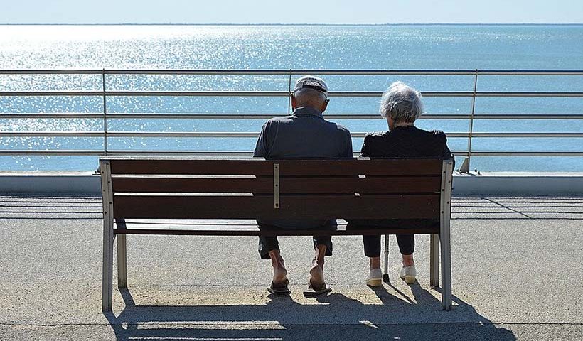 Elderly Couple Looking Out to Sea