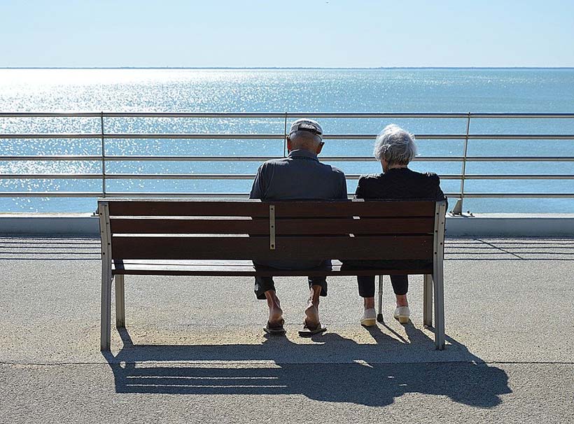 Elderly Couple Looking Out to Sea
