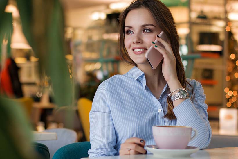 Young Woman on Phone with Coffee