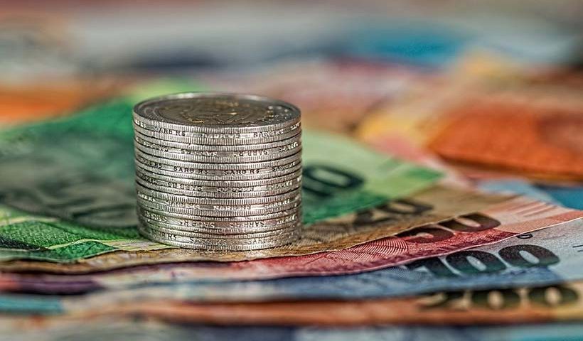 Stack of Coins on Bank Notes