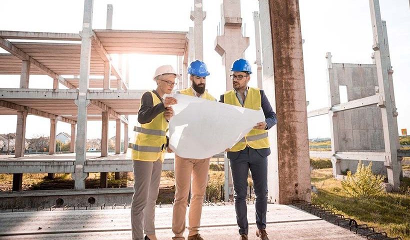 3 People Reviewing Architects Drawings