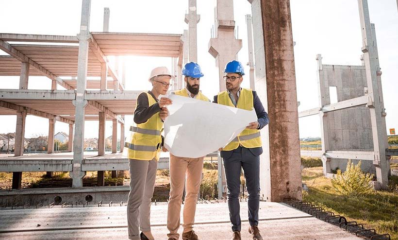 3 People Reviewing Architects Drawings