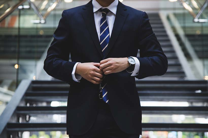 Man Buttoning Suit Jacket