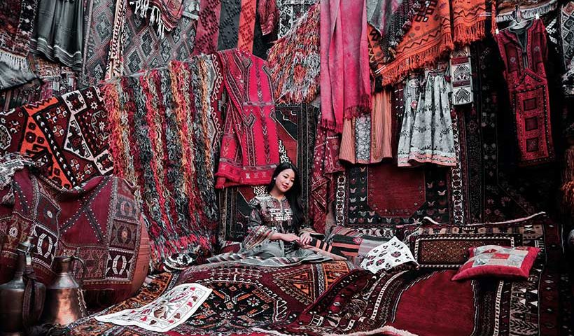 Asian Woman Selling Carpets