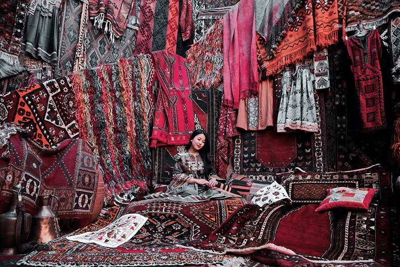 Asian Woman Selling Carpets