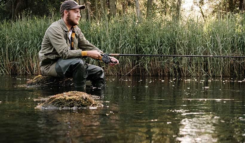 Man Sat Fishing in a River