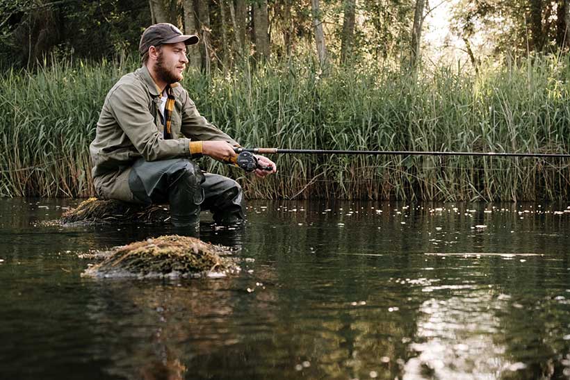 Man Sat Fishing in a River